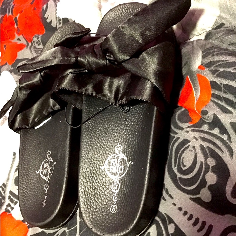 All black bow tied slides